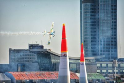 Smoke stacks in city against sky