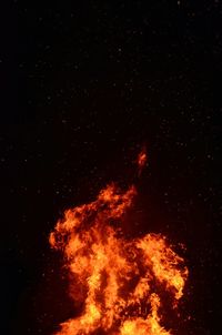 Low angle view of bonfire against star field at night