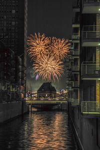 Firework display in city at night