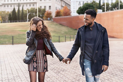 Smiling couple holding walking outdoors