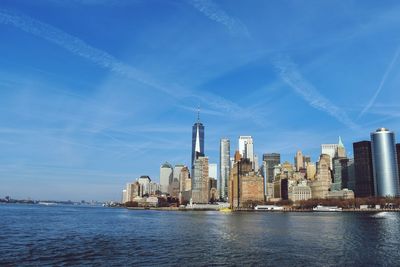 Modern buildings in city against blue sky