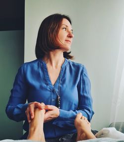 Young woman looking away while doing reflexology 