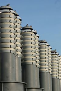 Low angle view of industry against clear sky