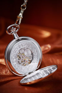 Close-up of pocket watch on table