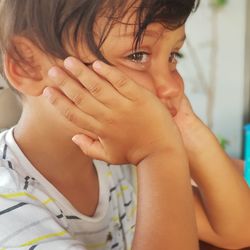 Close-up of cute boy crying at home