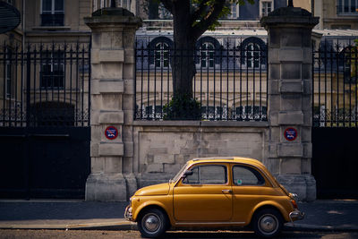 Yellow car parked in paris. bright retro car.