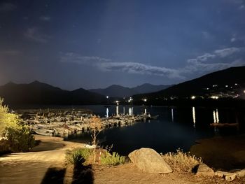 Scenic view of lake against sky at night