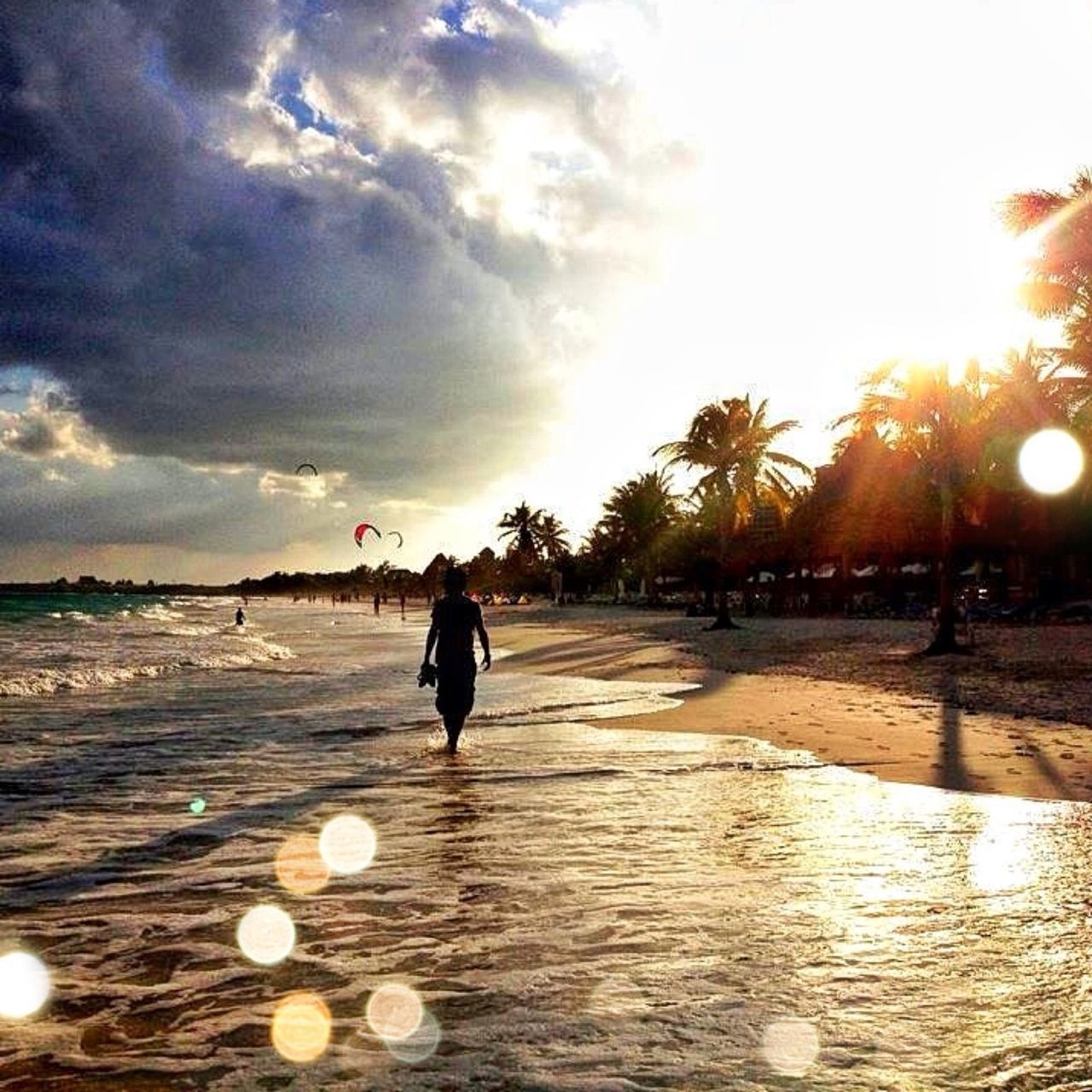 beach, sky, lifestyles, leisure activity, sunset, sea, full length, walking, sun, shore, sand, water, rear view, silhouette, sunlight, cloud - sky, person, beauty in nature