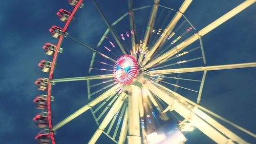 Low angle view of ferris wheel against sky