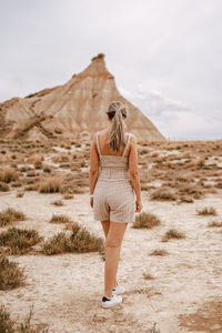 Full length rear view of woman walking on street