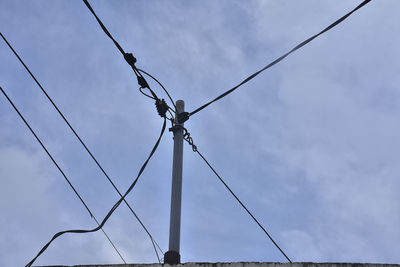 Low angle view of electricity pylon against sky