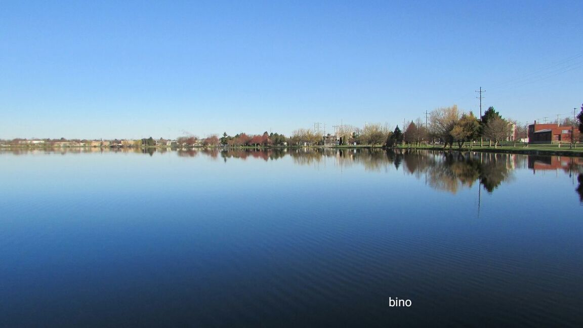 copy space, water, clear sky, built structure, lake, reflection, day, blue, outdoors, waterfront, architecture, nature, no people, sky, building exterior, scenics