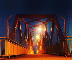 Low angle view of illuminated bridge against sky at night