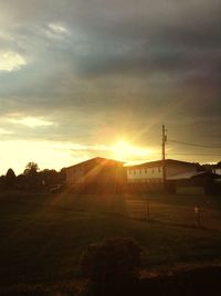 Scenic view of silhouette field against sky during sunset