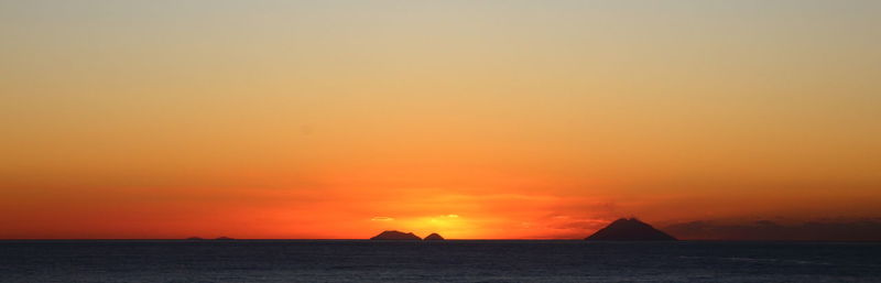 Scenic view of sea against orange sky