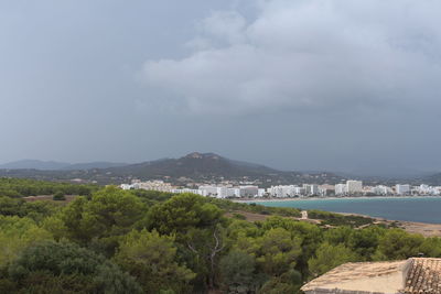 Scenic view of trees and buildings against sky