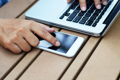 Midsection of man using mobile phone