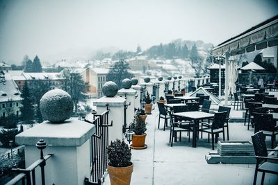 Buildings in snow covered city against clear sky