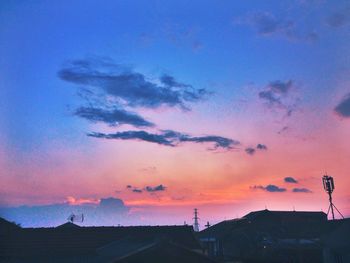 Silhouette of trees against dramatic sky