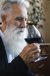 Close-up of man holding wineglass