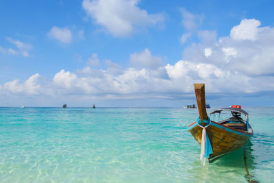 Fishing boat in sea against sky