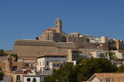 Low angle view of buildings against blue sky