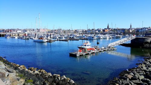 Boats moored at harbor