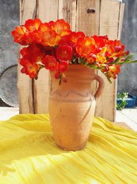 Close-up of red flower vase on table