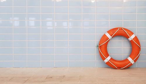 Life belt on tiled floor against wall