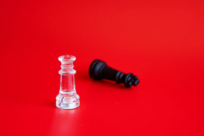 Close-up of chess pieces on red table