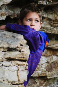 Portrait of boy playing on rock