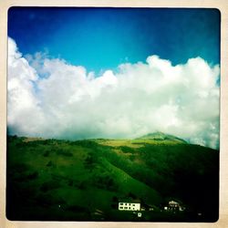 Scenic view of landscape against cloudy sky