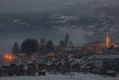 High angle view of illuminated buildings in city during winter