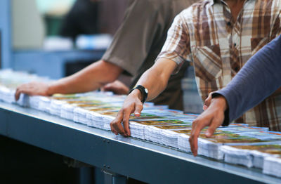 Midsection of workers working at factory