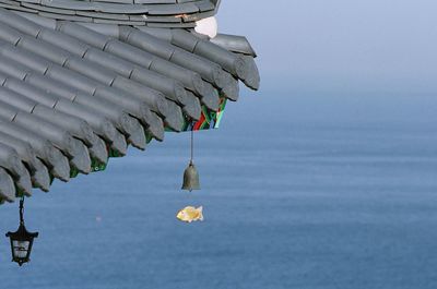 Decoration hanging from roof by sea