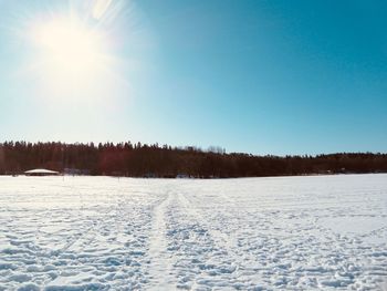 Scenic view of snow covered land against clear sky during winter