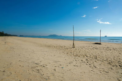 Scenic view of beach against blue sky