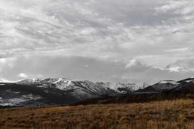 Scenic view of mountains against cloudy sky