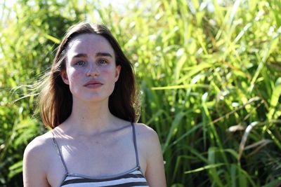 Portrait of woman on grassy field