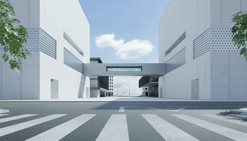 Road amidst buildings against sky in city