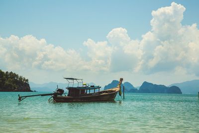 Boat sailing on sea against sky