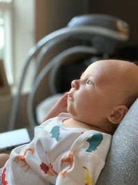 Cute baby lying on bed at home