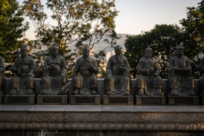 Statues against trees and plants