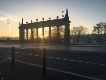 Silhouette of man standing on railing