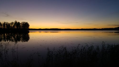 Scenic view of lake at sunset