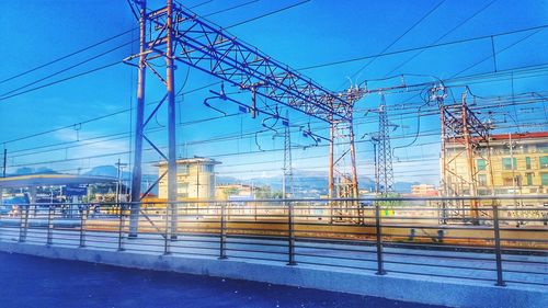 Electricity pylon against blue sky at dusk