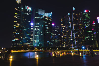 Illuminated modern buildings in city at night