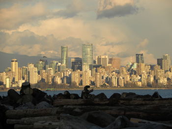 View of city buildings against cloudy sky