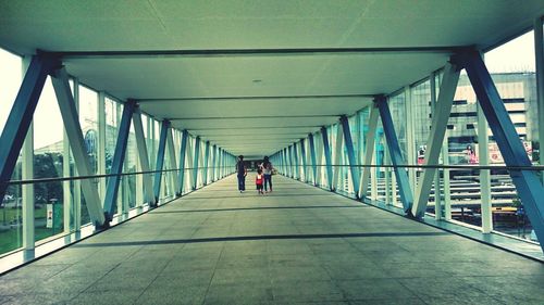 Rear view of family walking on elevated walkway