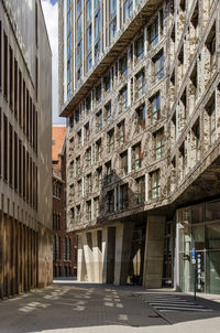 Narrow and winding alley between modern buildings in the city center